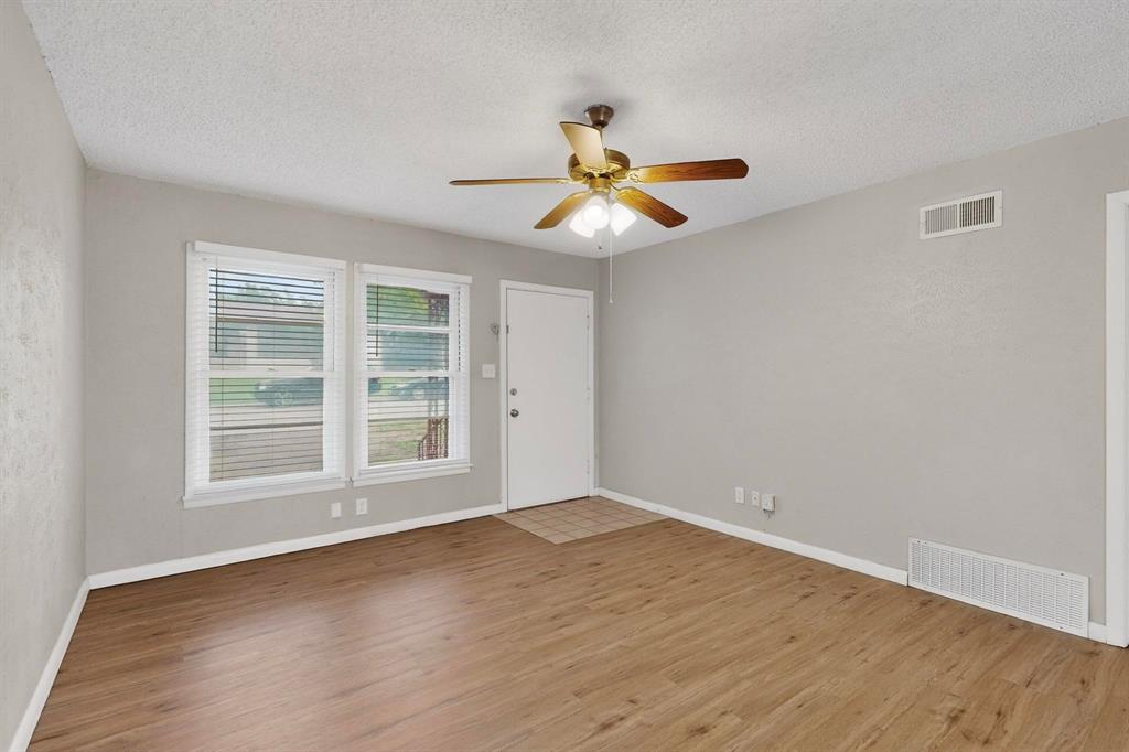 4508 Rutland Avenue Fort Worth, TX 76133 - Photo 6 of 36 a view of empty room with wooden floor and fan