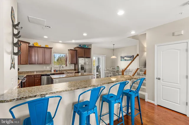 a bath room with a toilet a mirror and a shower