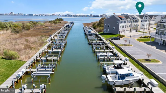 a front view of a building with lot of cars parked on road