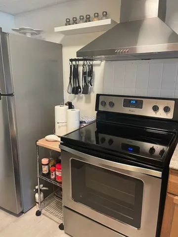 a stove top oven sitting inside of a kitchen