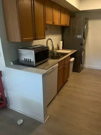 a kitchen with stainless steel appliances granite countertop a sink a stove and a refrigerator