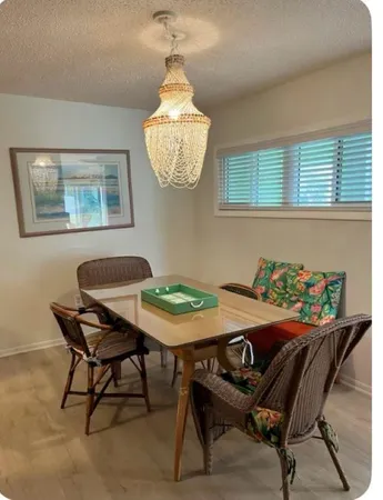 a view of a dining room with furniture and chandelier