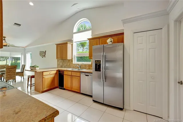 a kitchen with a refrigerator and a sink