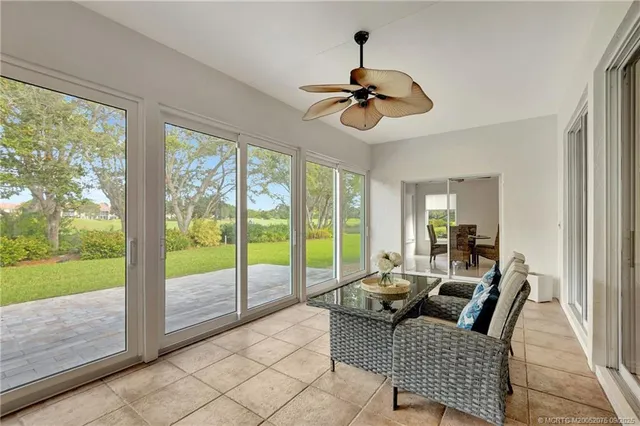 a living room with furniture and a floor to ceiling window