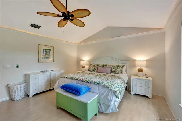 a bedroom with a bed and ceiling fan