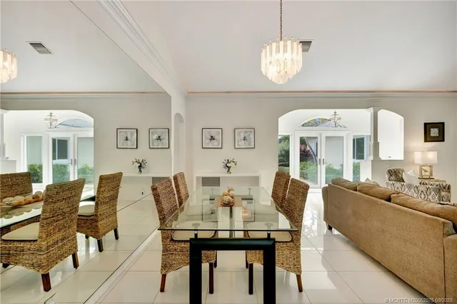a view of a dining room with furniture wooden floor and chandelier