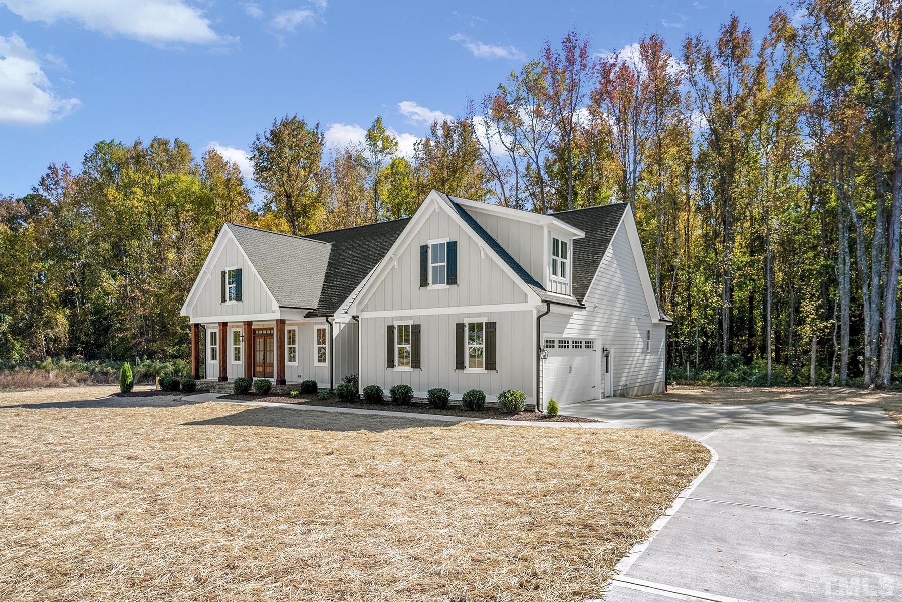 10316 Ten-Ten Road Raleigh, NC 27603 - Photo 3 of 3 a front view of a house with a yard and trees