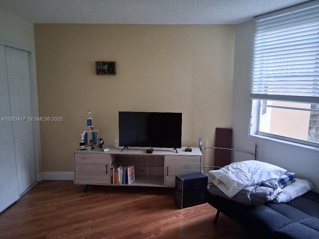 1400 St Charles Place, Unit 201 Pembroke Pines, FL 33026 - Photo 14 of 23 a bedroom with a bed and a flat screen tv