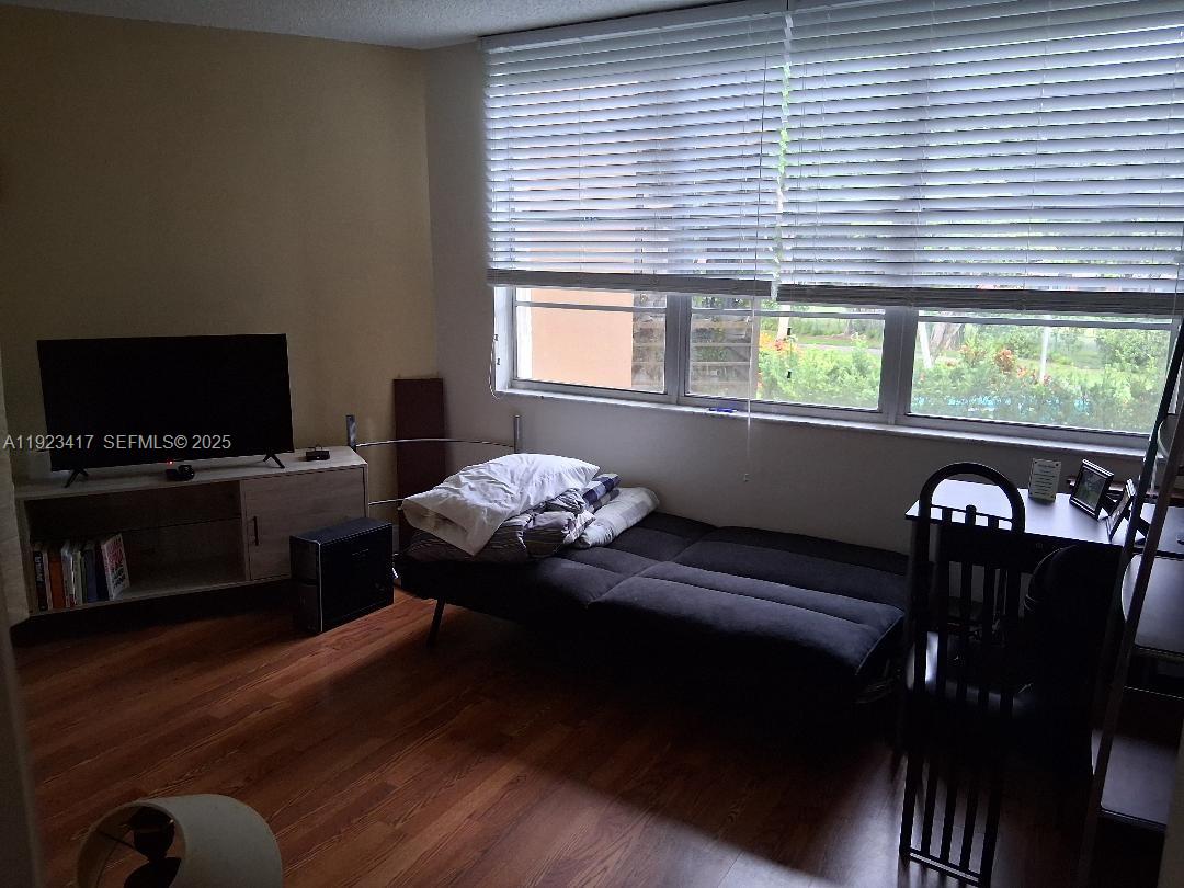 1400 St Charles Place, Unit 201 Pembroke Pines, FL 33026 - Photo 15 of 23 a living room with furniture and a flat screen tv