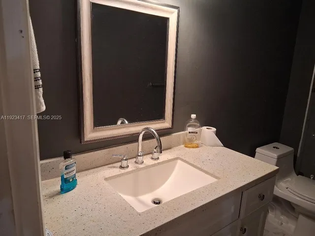 a bathroom with a toilet a sink and shower