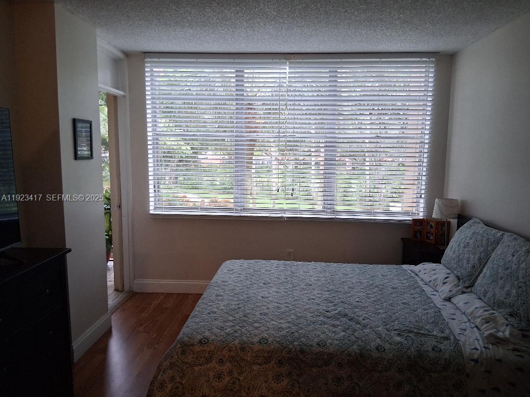 1400 St Charles Place, Unit 201 Pembroke Pines, FL 33026 - Photo 19 of 23 a bedroom with a bed and a window