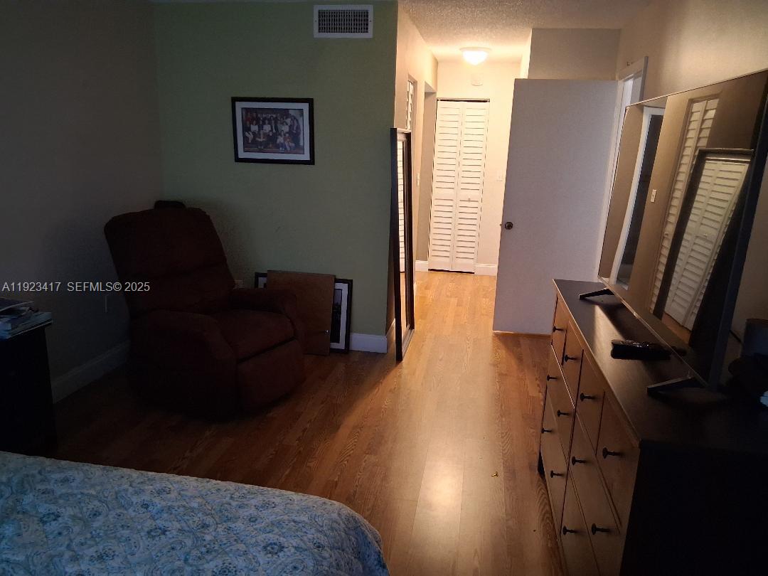 1400 St Charles Place, Unit 201 Pembroke Pines, FL 33026 - Photo 20 of 23 a living room with furniture and a flat screen tv