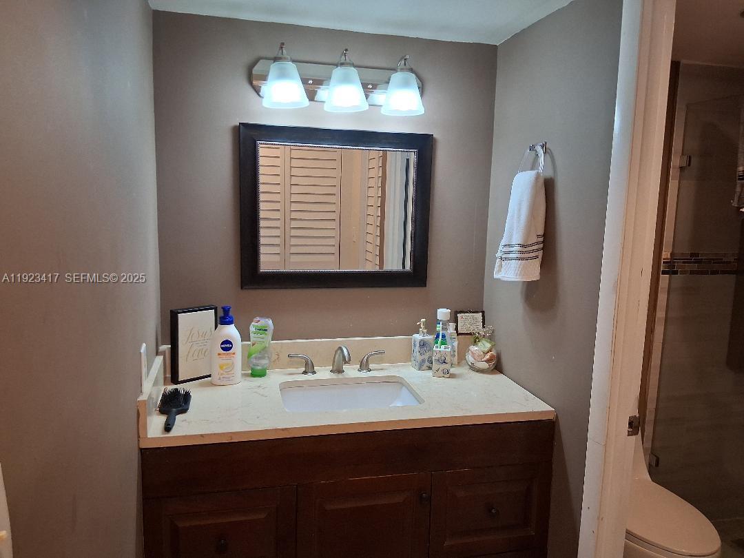 1400 St Charles Place, Unit 201 Pembroke Pines, FL 33026 - Photo 22 of 23 a bathroom with a sink vanity and a mirror