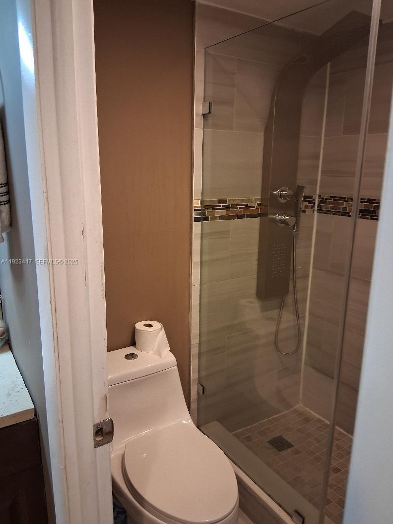 1400 St Charles Place, Unit 201 Pembroke Pines, FL 33026 - Photo 23 of 23 a bathroom with a toilet and a shower