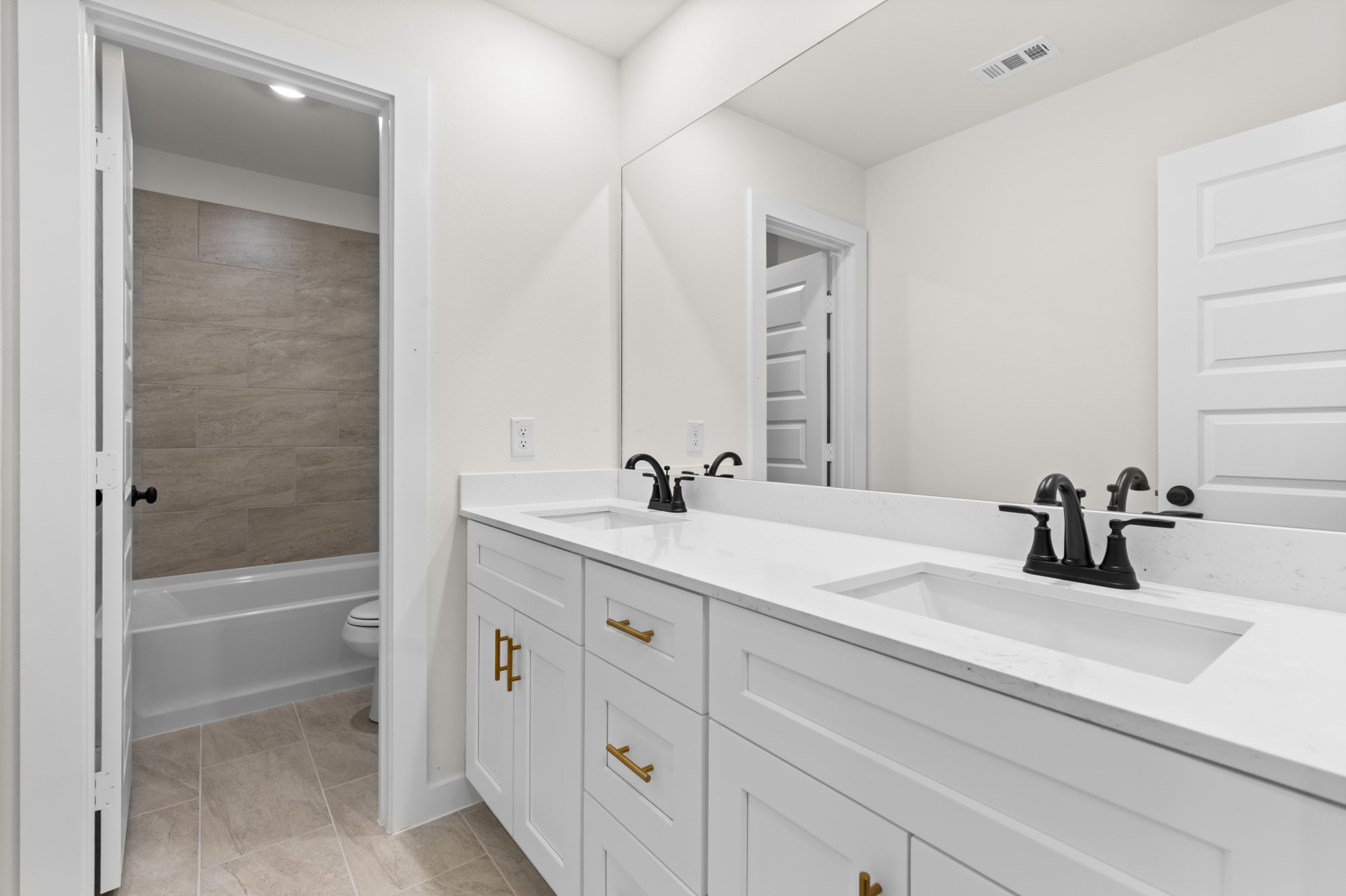 3518 Windmill Palm Manvel, TX 77578 - Photo 14 of 21 a bathroom with a double vanity sink and mirror with bathtub