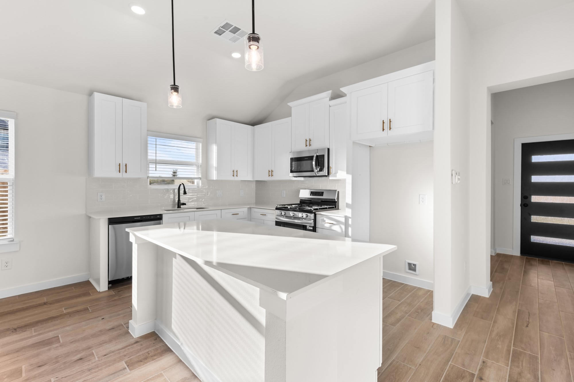3518 Windmill Palm Manvel, TX 77578 - Photo 7 of 21 a kitchen with kitchen island a sink a stove a refrigerator cabinets and wooden floor