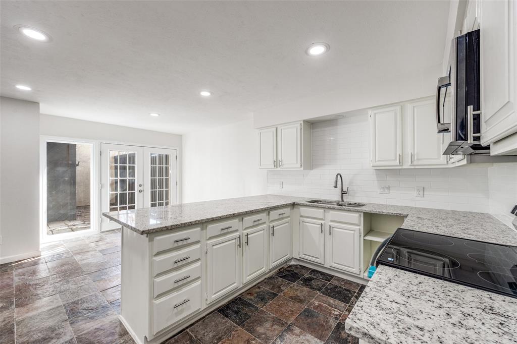 9838 Baseline Drive Dallas, TX 75243 - Photo 11 of 33 a kitchen with a sink stove and cabinets