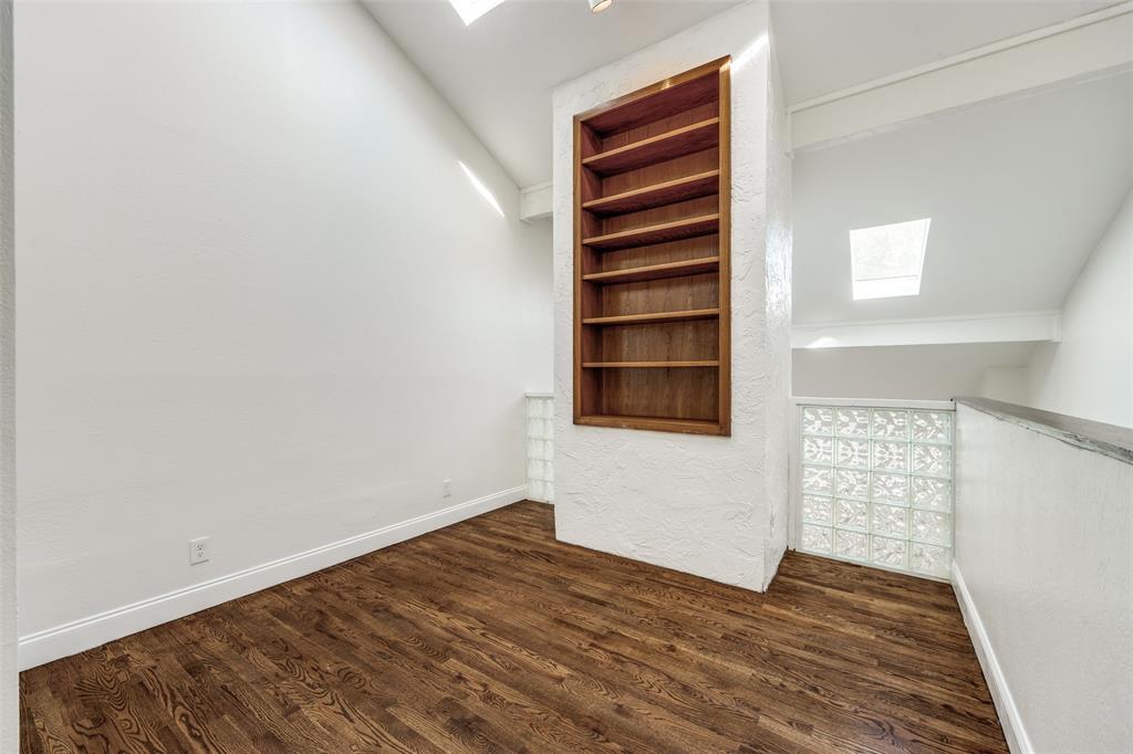 9838 Baseline Drive Dallas, TX 75243 - Photo 14 of 33 a view of empty room with wooden floor and fan
