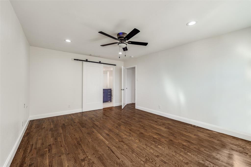 9838 Baseline Drive Dallas, TX 75243 - Photo 16 of 33 a view of an empty room with a ceiling fan