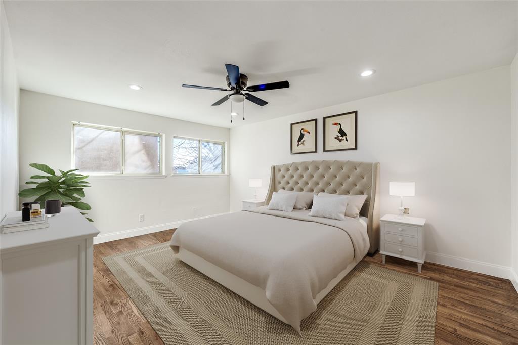 9838 Baseline Drive Dallas, TX 75243 - Photo 18 of 33 a bedroom with a large bed and a potted plant