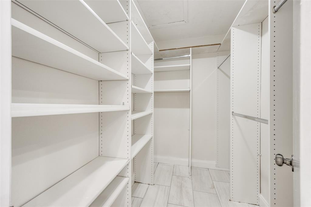 9838 Baseline Drive Dallas, TX 75243 - Photo 20 of 33 a view of walk in closet with empty racks