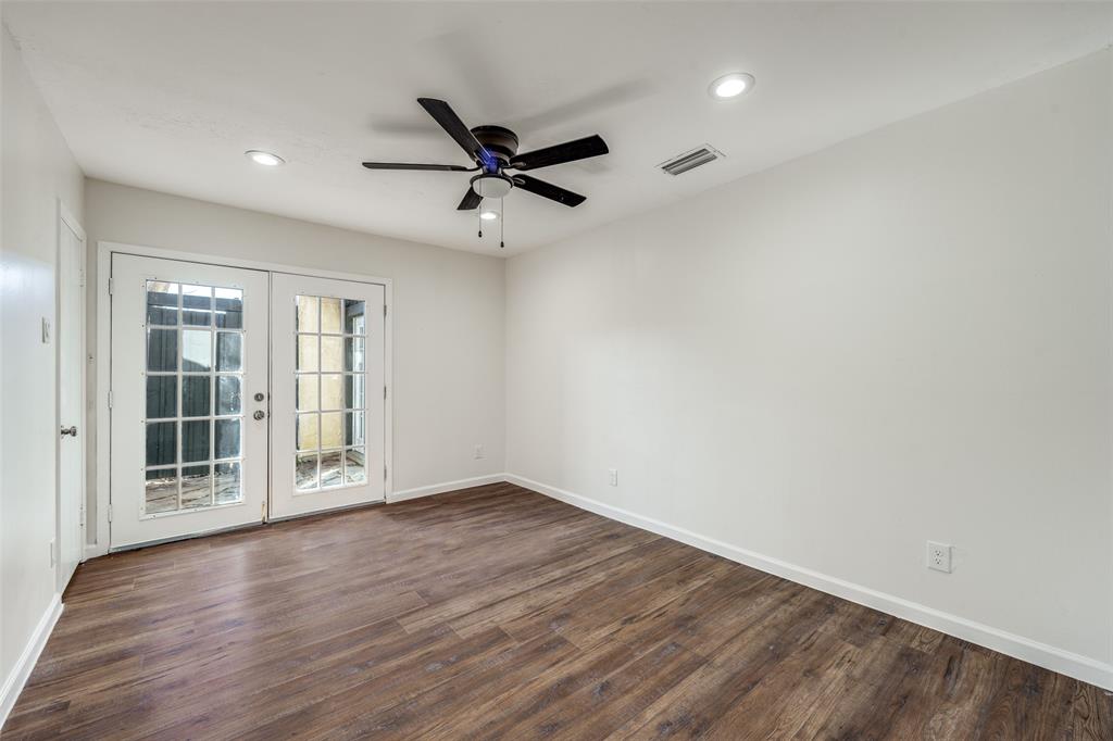 9838 Baseline Drive Dallas, TX 75243 - Photo 22 of 33 a view of empty room with wooden floor and fan