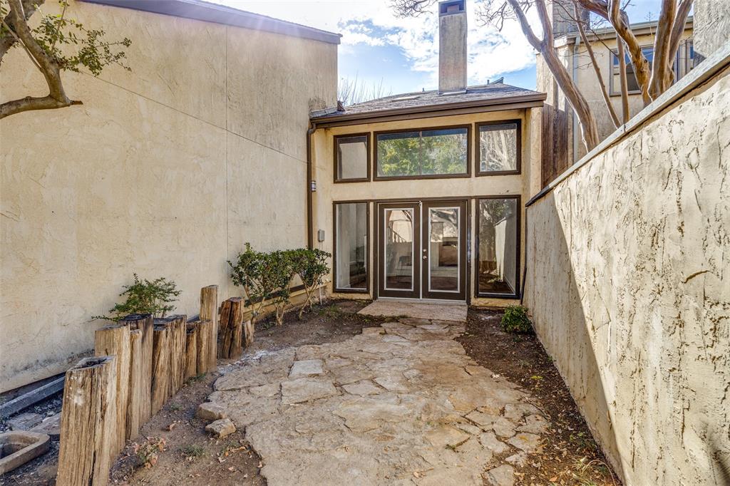 9838 Baseline Drive Dallas, TX 75243 - Photo 27 of 33 a view of a house with a small yard and floor to ceiling window