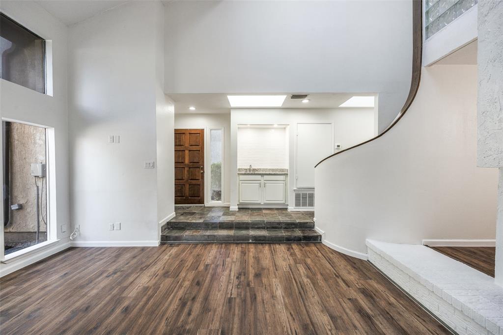 9838 Baseline Drive Dallas, TX 75243 - Photo 3 of 33 a view of a room with wooden floor and staircase