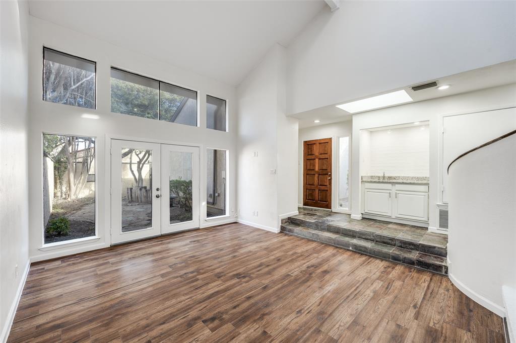 9838 Baseline Drive Dallas, TX 75243 - Photo 4 of 33 a view of empty room with wooden floor and fan