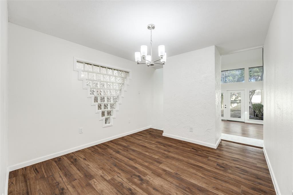 9838 Baseline Drive Dallas, TX 75243 - Photo 6 of 33 wooden floor in an empty room with a window