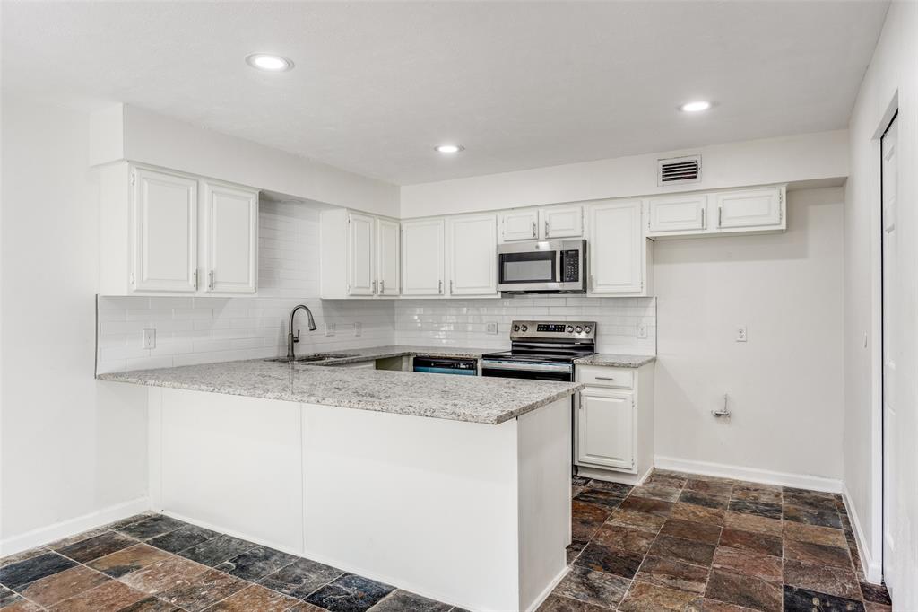 9838 Baseline Drive Dallas, TX 75243 - Photo 8 of 33 a kitchen with stainless steel appliances granite countertop a stove a sink and a refrigerator