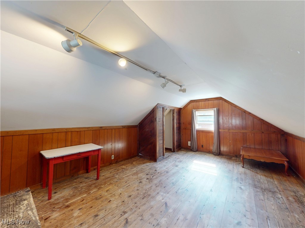 1136 Erieview Road Cleveland Heights, OH 44121 - Photo 33 of 45 Additional living space featuring wood walls, light wood-style flooring, and vaulted ceiling
