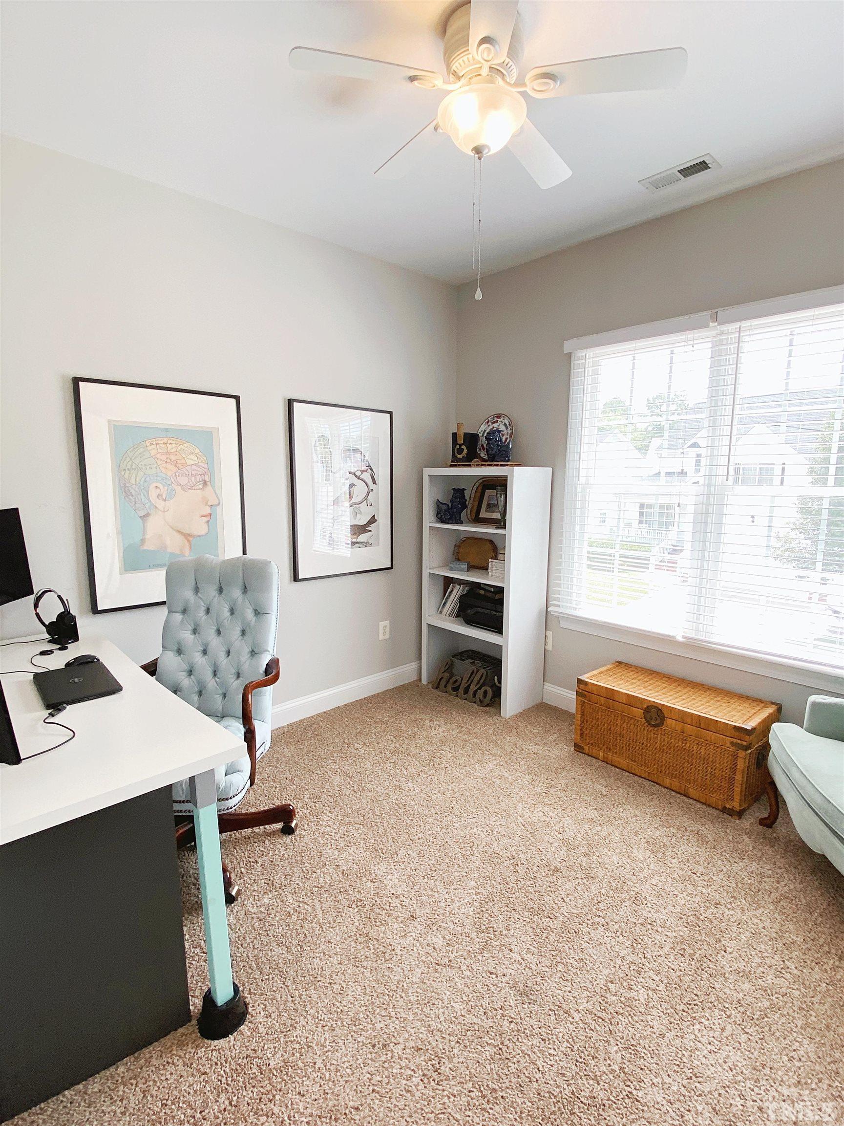 7932 Milltrace Run Raleigh, NC 27615 - Photo 11 of 36 a living room with furniture and a flat screen tv