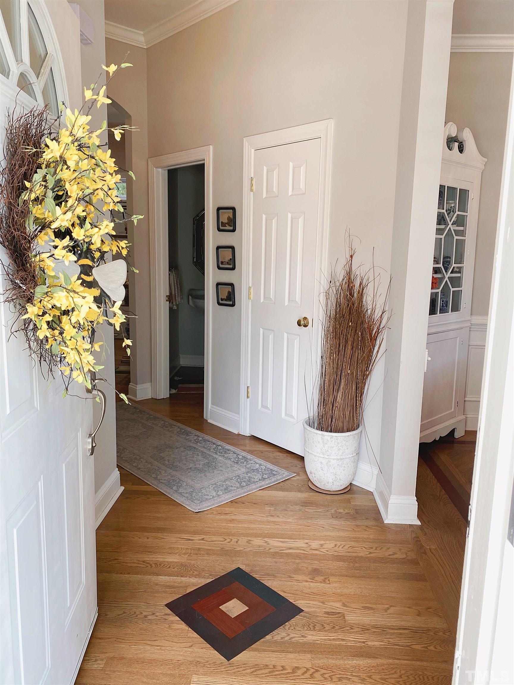 7932 Milltrace Run Raleigh, NC 27615 - Photo 3 of 36 a view of entryway with livingroom and wooden floor