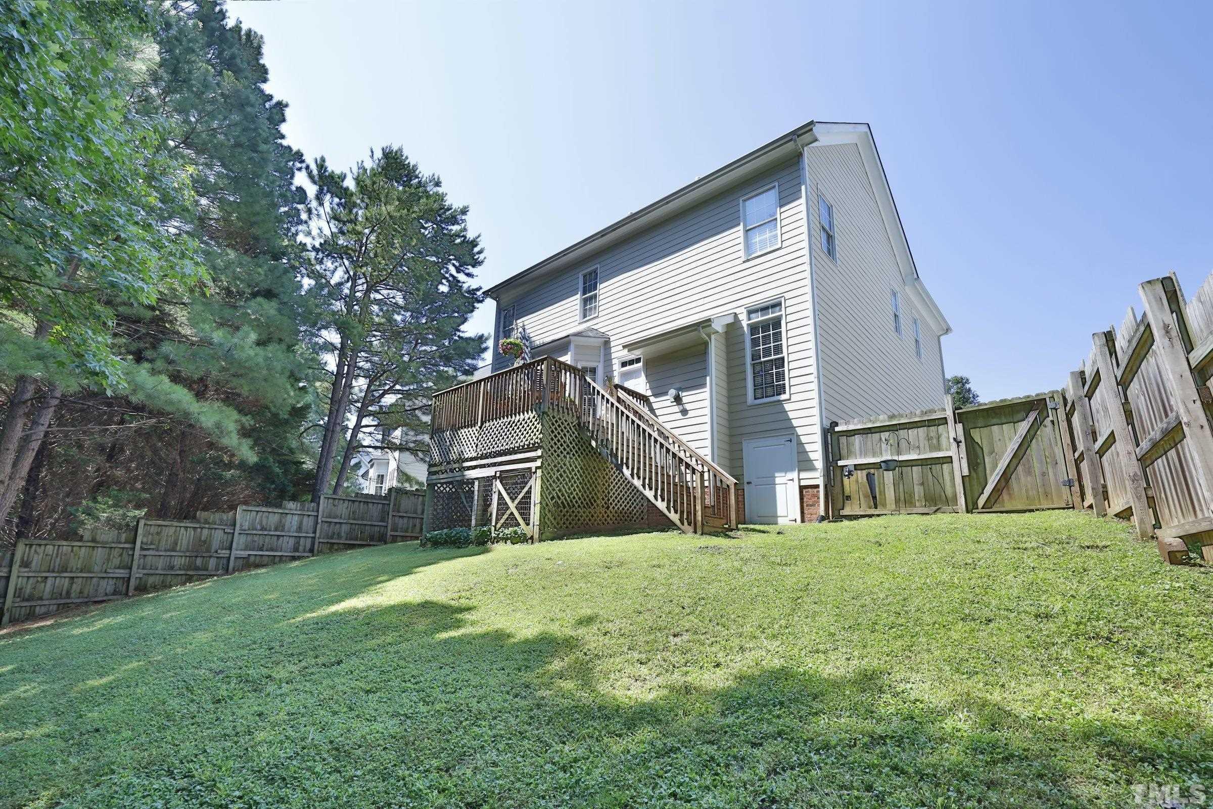 7932 Milltrace Run Raleigh, NC 27615 - Photo 32 of 36 a view of a house with a yard