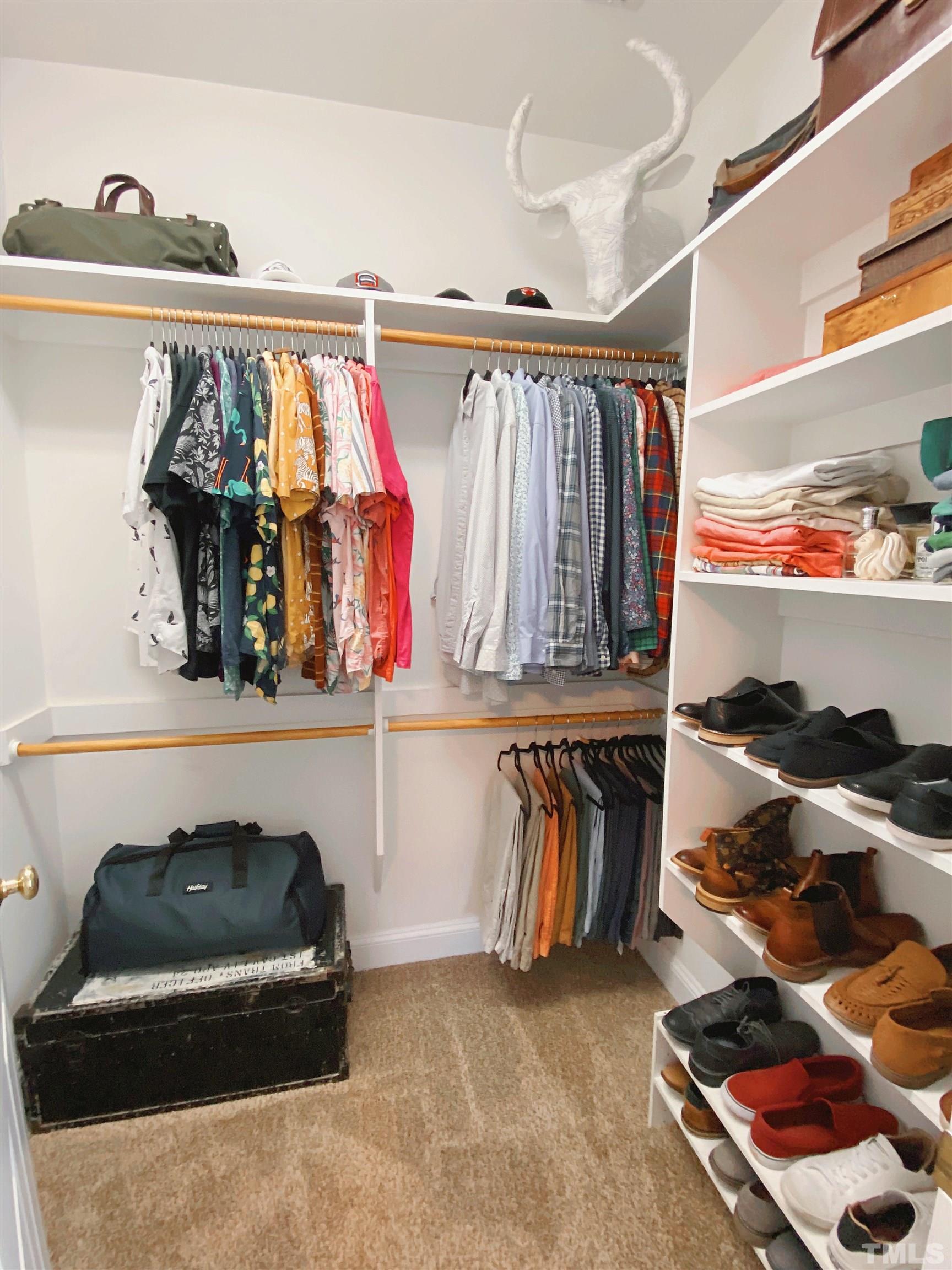 7932 Milltrace Run Raleigh, NC 27615 - Photo 10 of 36 a view of walk in closet with clothes and shoes