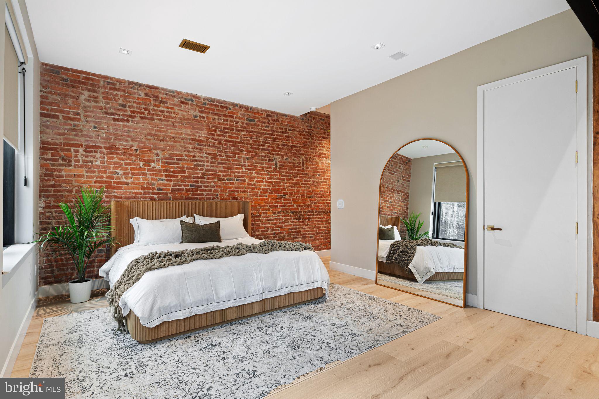 2017 Sansom Street Philadelphia, PA 19103 - Photo 24 of 51 a bedroom with a bed and a mirror