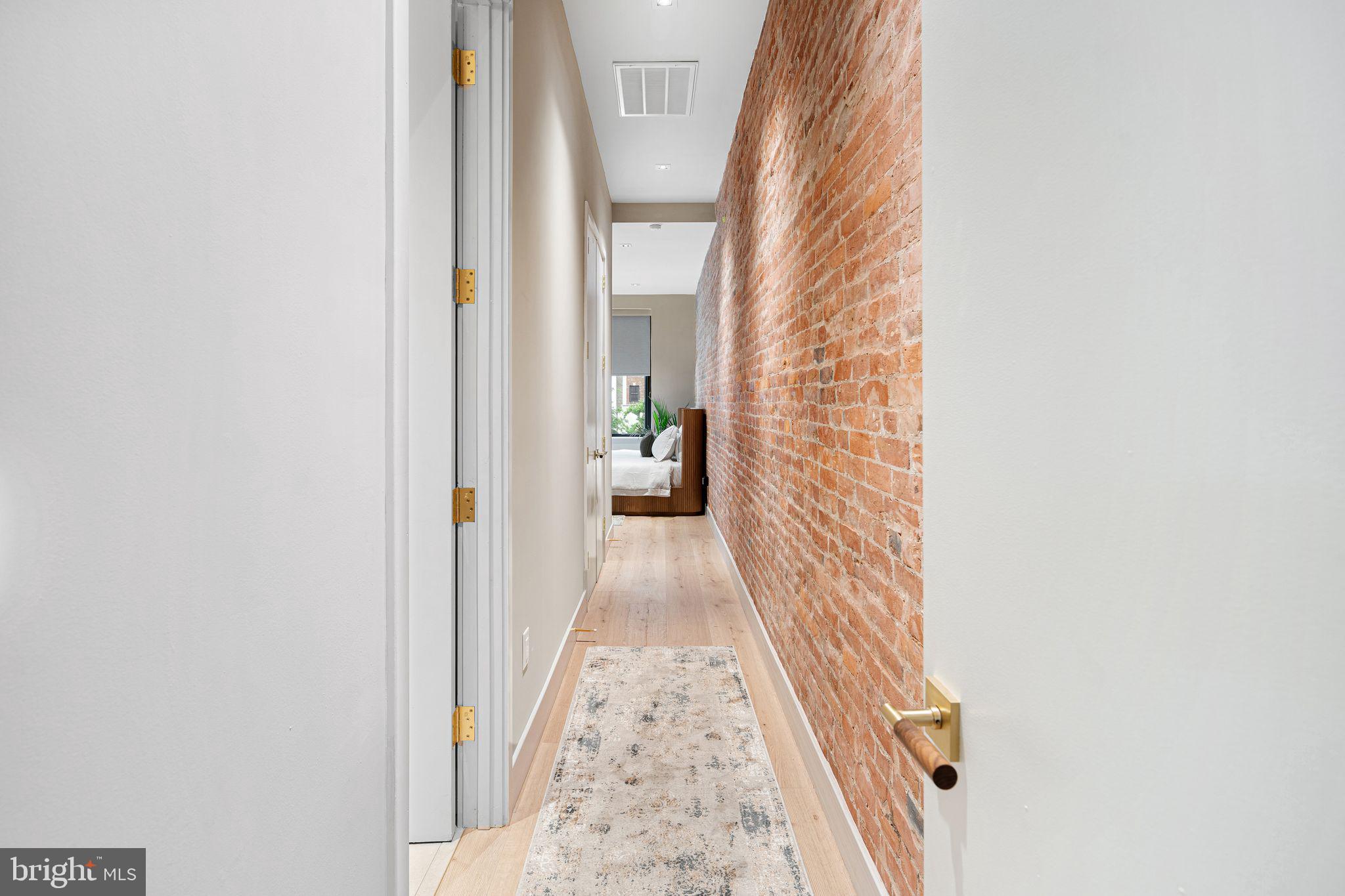 2017 Sansom Street Philadelphia, PA 19103 - Photo 31 of 51 a view of a hallway with wooden floor and a bathroom