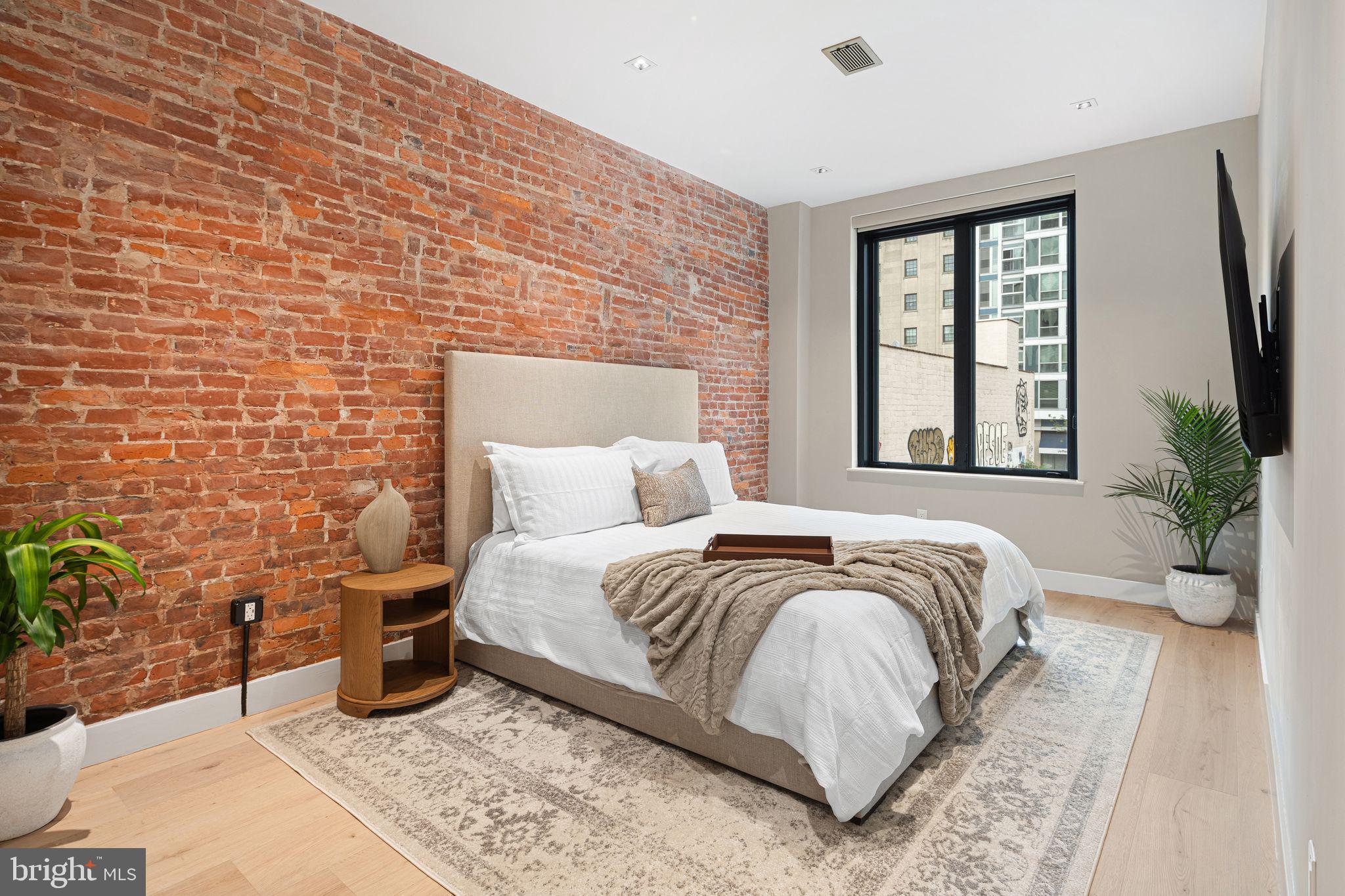 2017 Sansom Street Philadelphia, PA 19103 - Photo 32 of 51 a bedroom with a bed and a potted plant