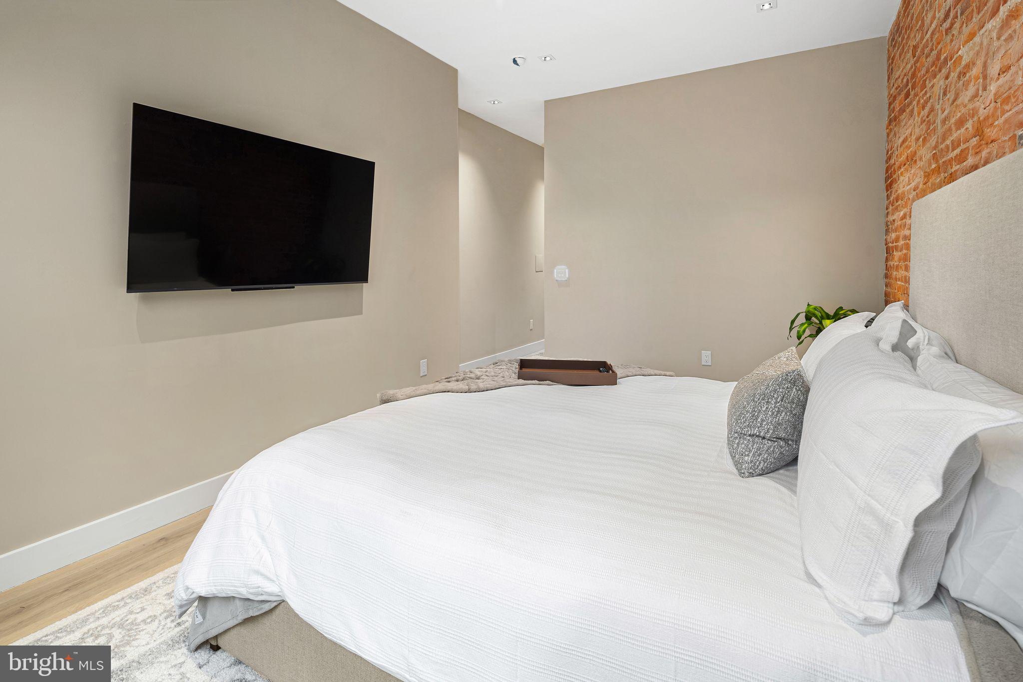 2017 Sansom Street Philadelphia, PA 19103 - Photo 33 of 51 a bedroom with a bed and a flat screen tv