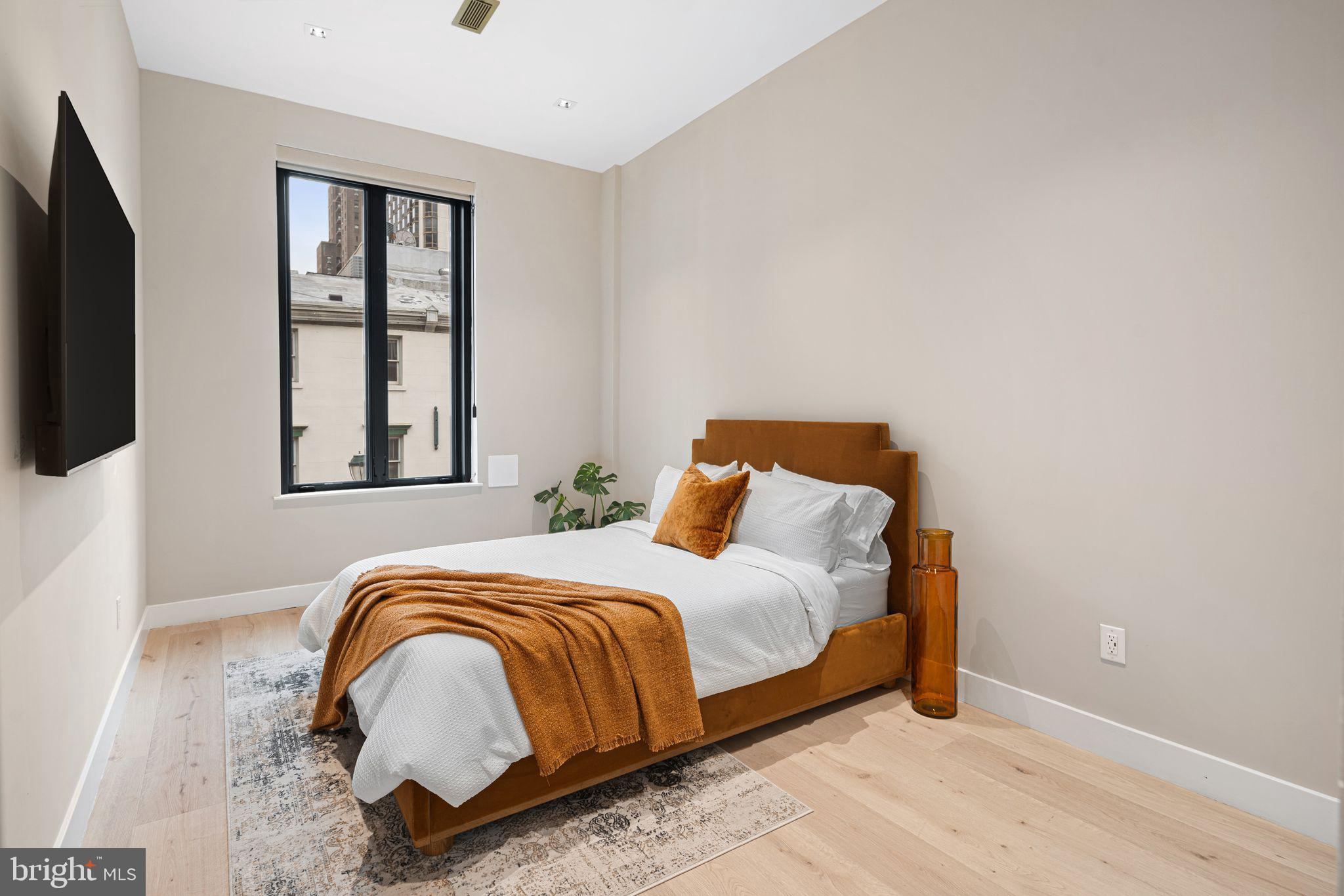 2017 Sansom Street Philadelphia, PA 19103 - Photo 37 of 51 a bedroom with a bed and a window