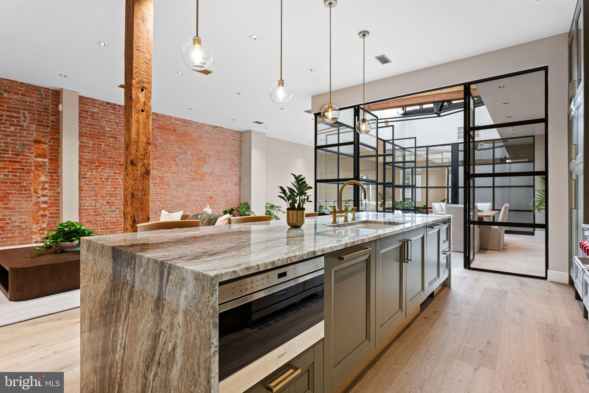2017 Sansom Street Philadelphia, PA 19103 - Photo 4 of 51 a large kitchen with stainless steel appliances a sink and a large window