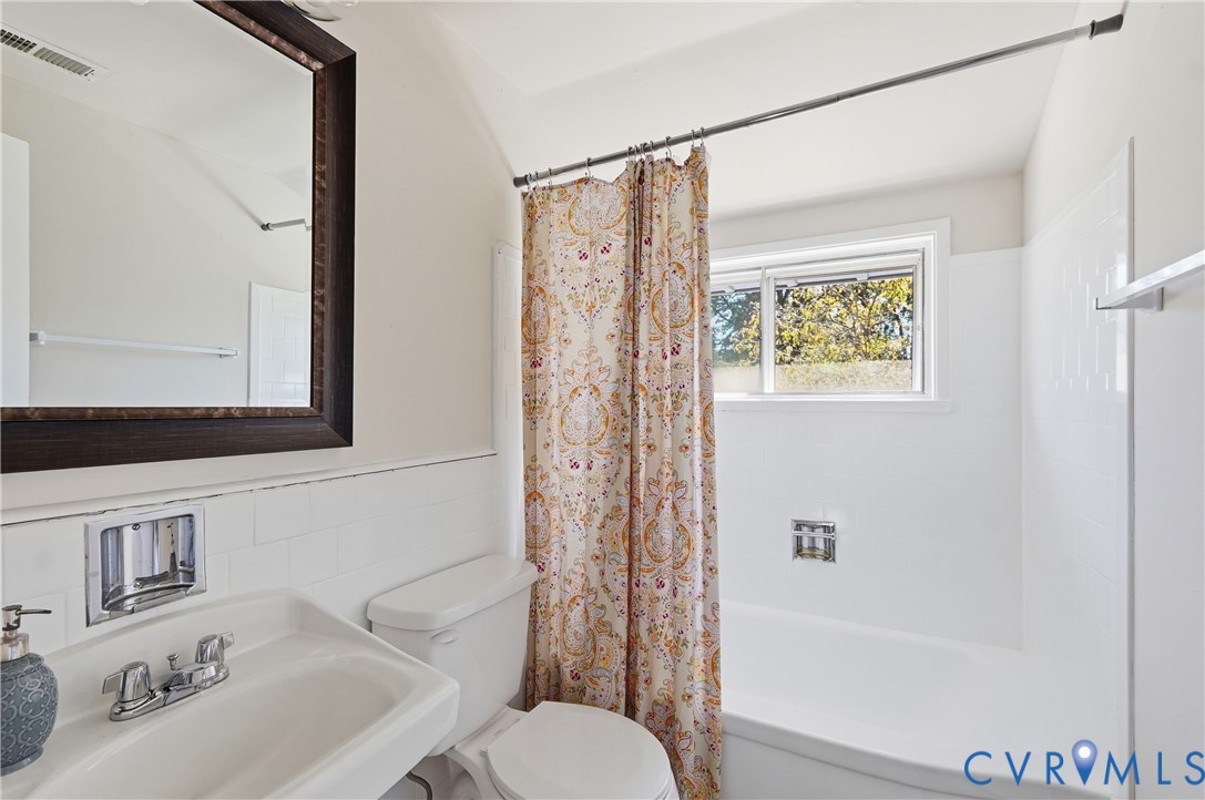 9207 Mapleway Road Richmond, VA 23229 - Photo 26 of 36 White subway tile wainscoting, framed vanity mirro
