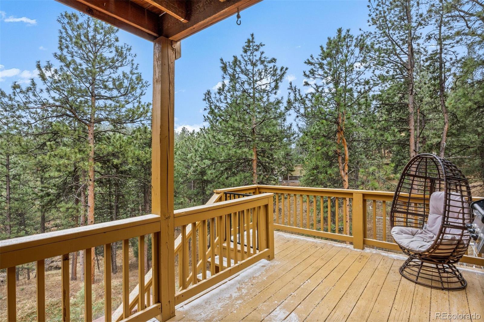 3154 South Piney Ridge Road Evergreen, CO 80439 - Photo 14 of 49 a view of a two chairs on the deck