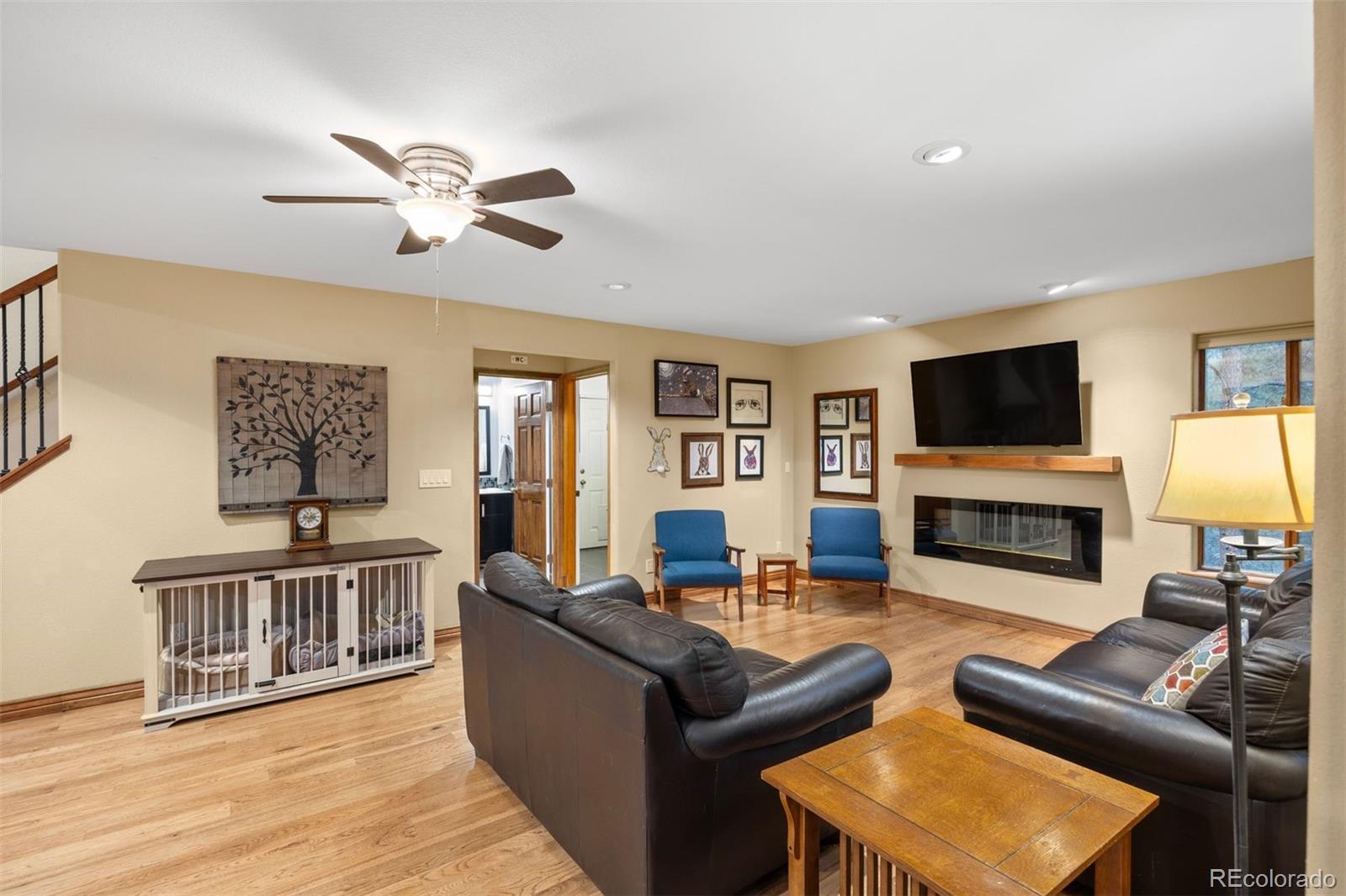 3154 South Piney Ridge Road Evergreen, CO 80439 - Photo 15 of 49 a living room with fireplace furniture and a flat screen tv