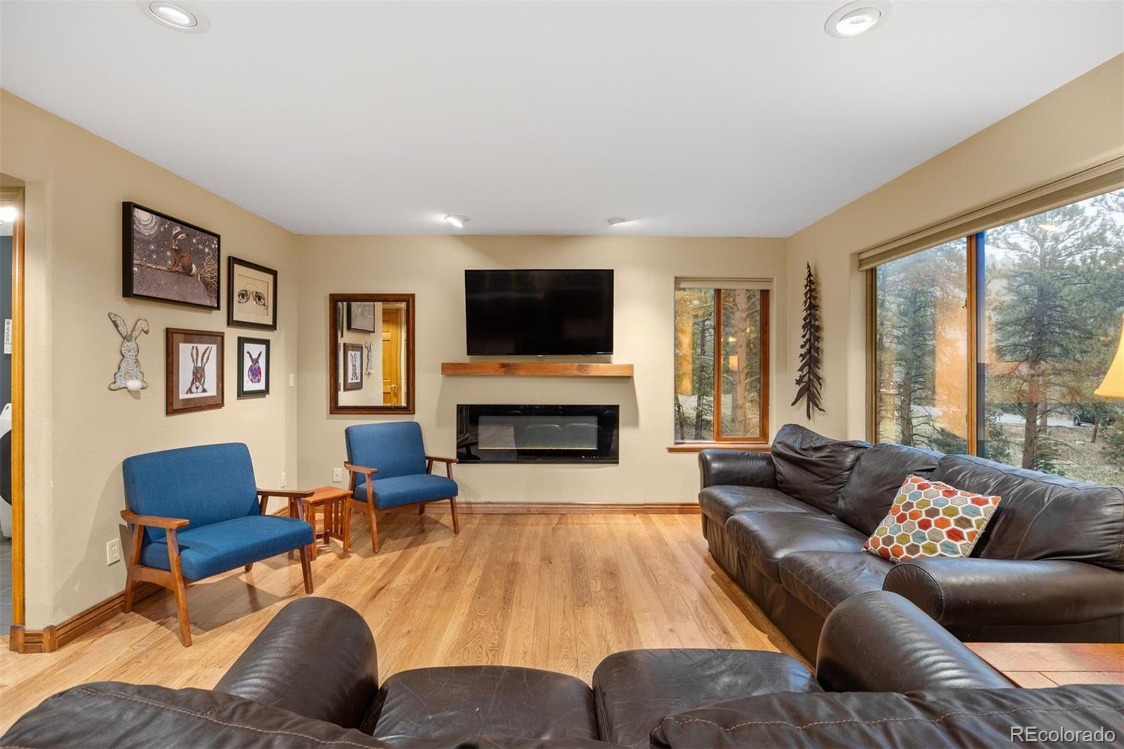 3154 South Piney Ridge Road Evergreen, CO 80439 - Photo 16 of 49 a living room with furniture fireplace and a large window