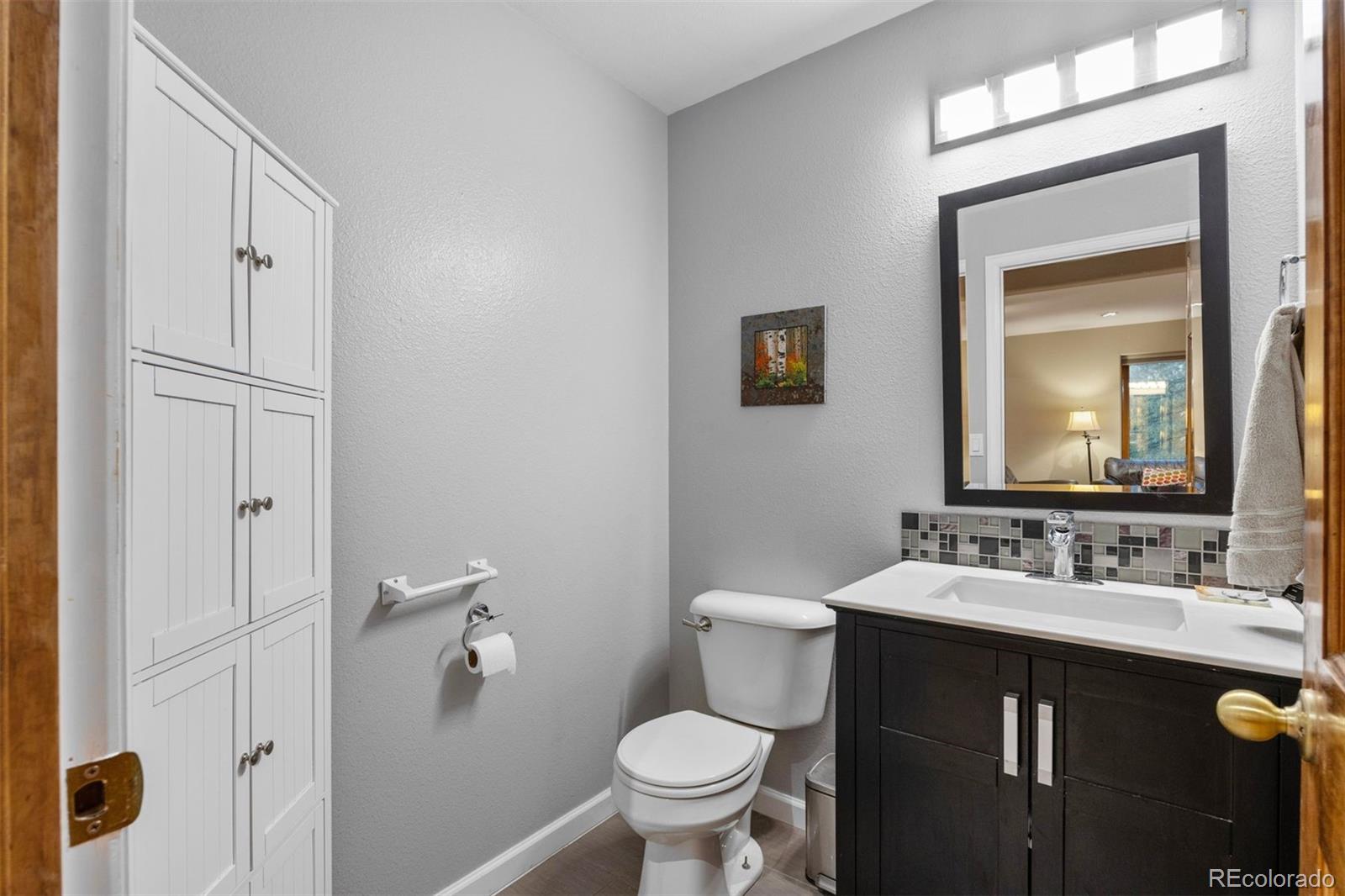 3154 South Piney Ridge Road Evergreen, CO 80439 - Photo 17 of 49 a bathroom with a sink and a toilet