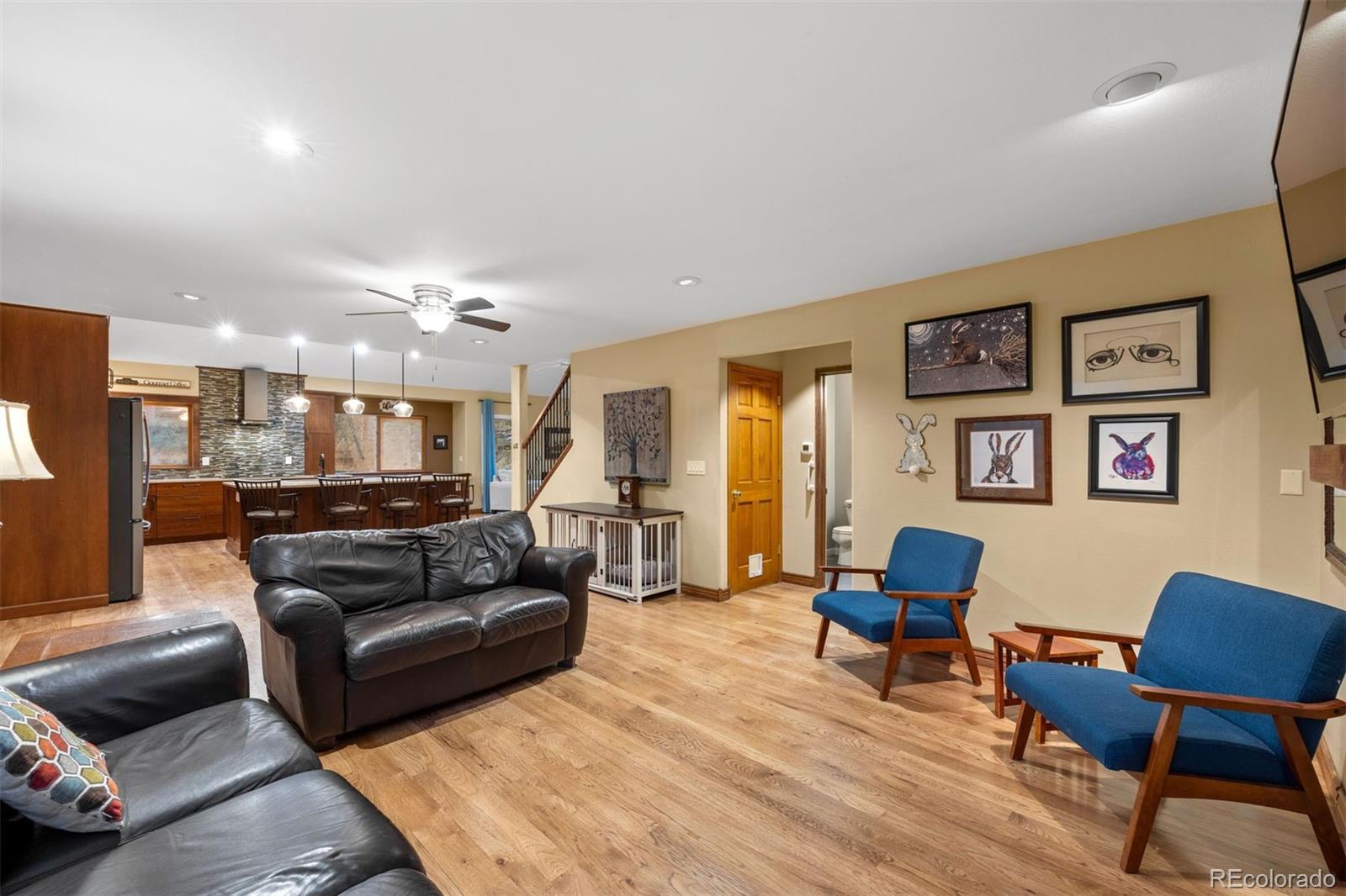 3154 South Piney Ridge Road Evergreen, CO 80439 - Photo 18 of 49 a living room with furniture and a wooden floor