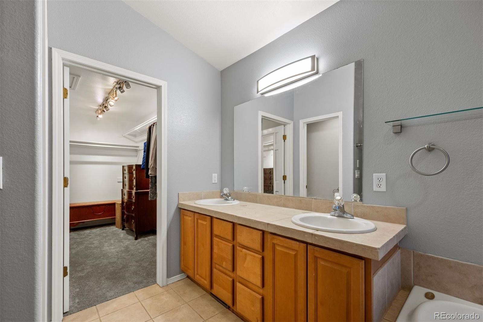 3154 South Piney Ridge Road Evergreen, CO 80439 - Photo 26 of 49 a bathroom with a sink a light fixture and a mirror