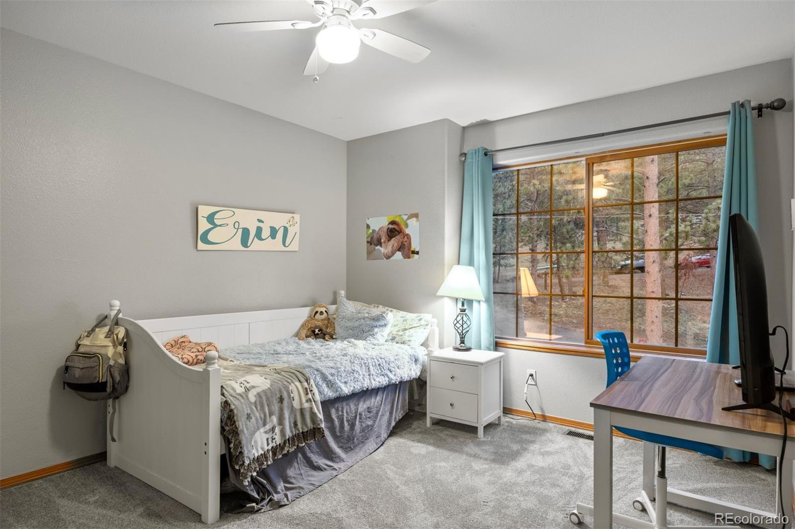 3154 South Piney Ridge Road Evergreen, CO 80439 - Photo 29 of 49 a bed room with a bed and a window